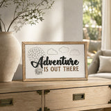 Adventure Is Out There balloon house framed wood sign styled on a light oak console in a sunlit conservatory
