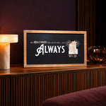 The Hollywood That Never Was tower hotel framed wood sign styled on a fluted walnut console in a screening lounge