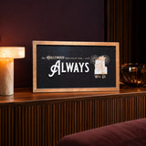 The Hollywood That Never Was tower hotel framed wood sign styled on a fluted walnut console in a screening lounge