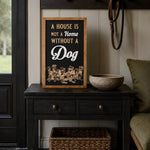 A House Is Not A Home Without A Dog framed wood sign styled on a black entry table in a boot room