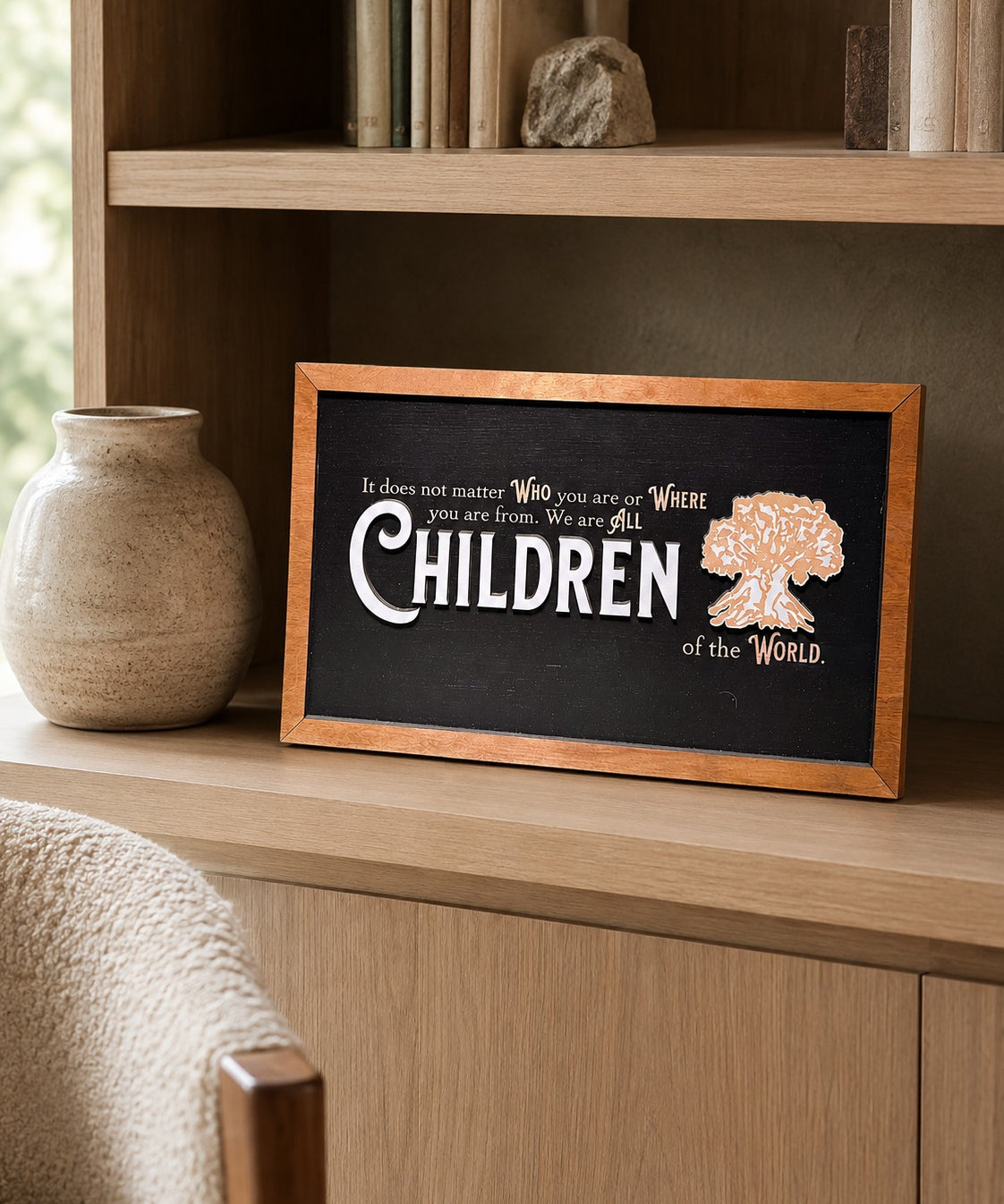 We Are All Children Of The World tree of life framed wood sign styled on an oak library shelf