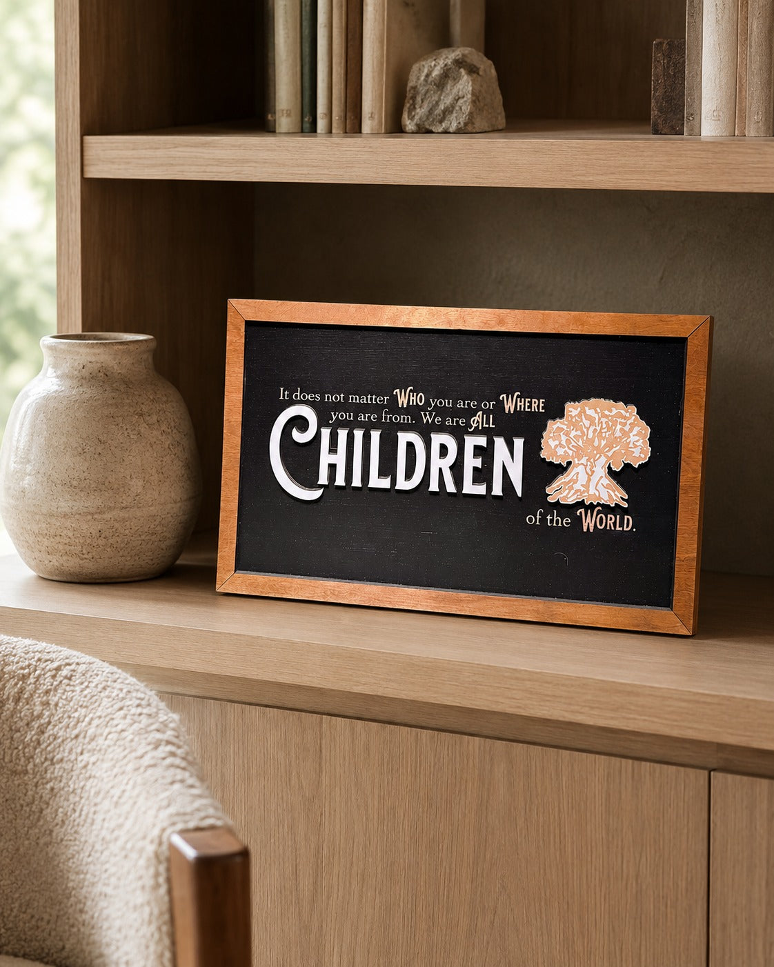 We Are All Children Of The World tree of life framed wood sign styled on an oak library shelf