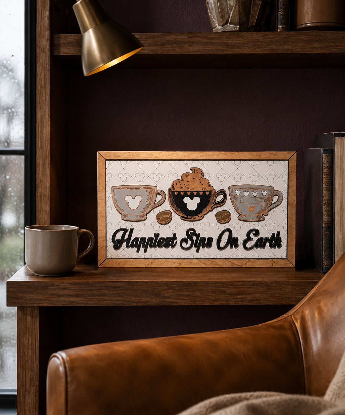 Happiest Sips On Earth coffee cups framed wood sign styled on a shelf in a luxury reading nook
