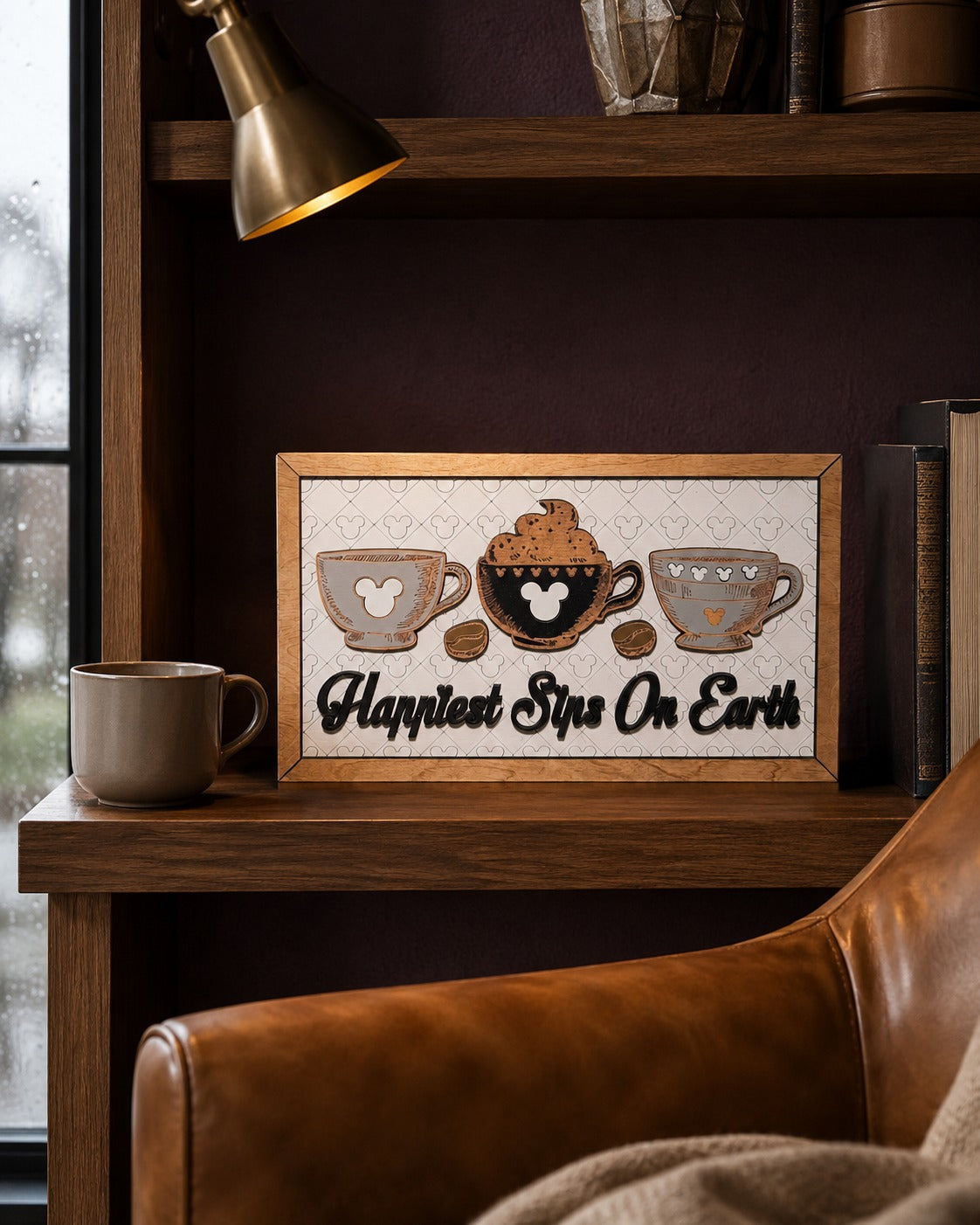 Happiest Sips On Earth coffee cups framed wood sign styled on a shelf in a luxury reading nook