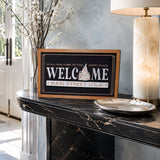 Welcome Main Street USA castle icon framed wood sign styled on a marble console in a luxury foyer