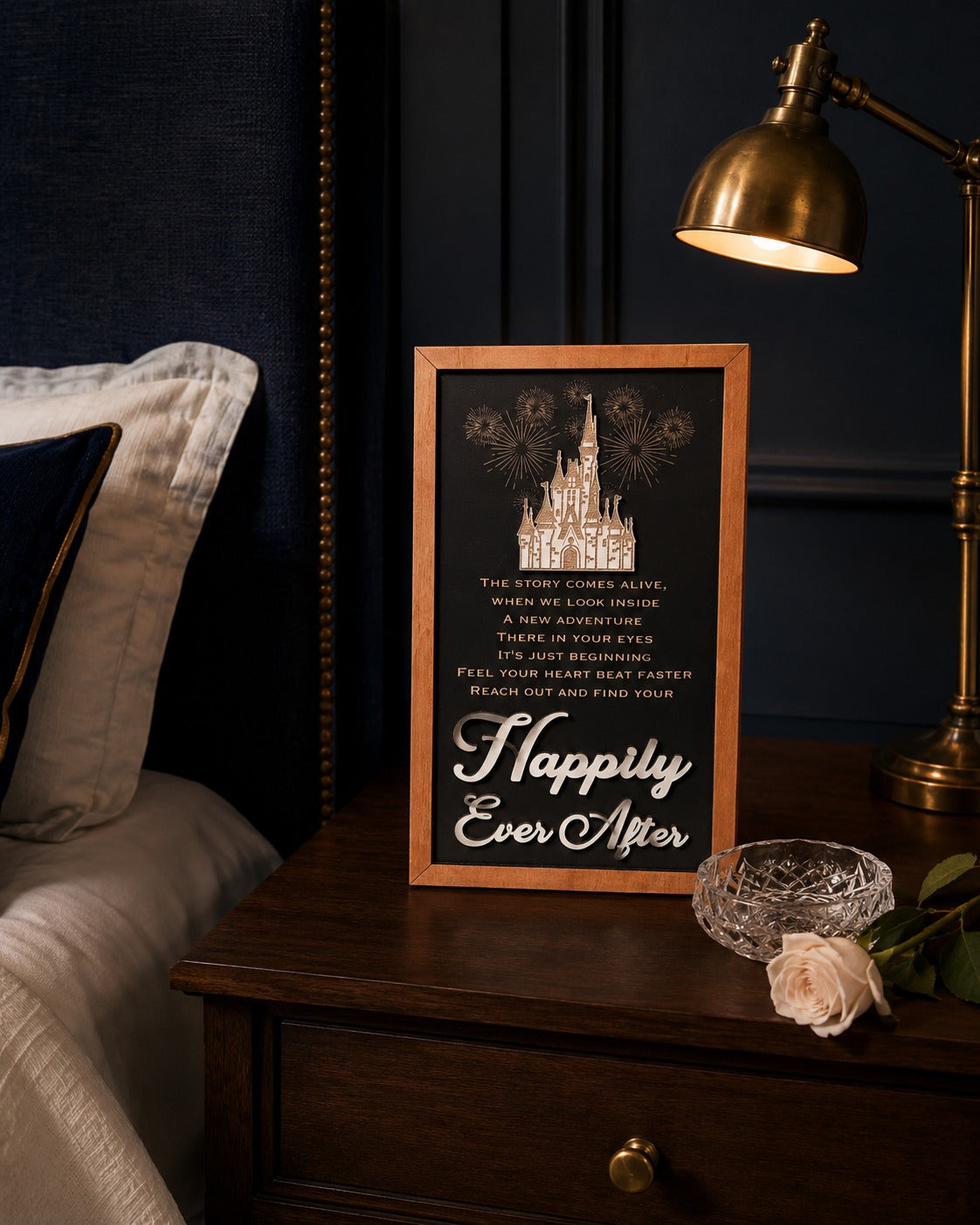 Reach Out And Find Your Happily Ever After lyrics fireworks framed wood sign styled on a nightstand in a midnight blue bedroom