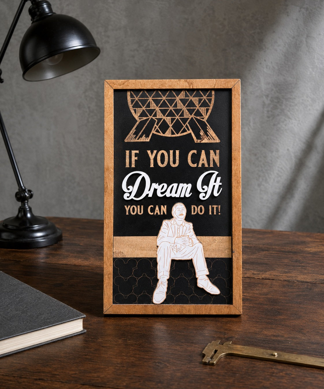 If You Can Dream It You Can Do It geodesic sphere framed wood sign styled on a dark oak desk