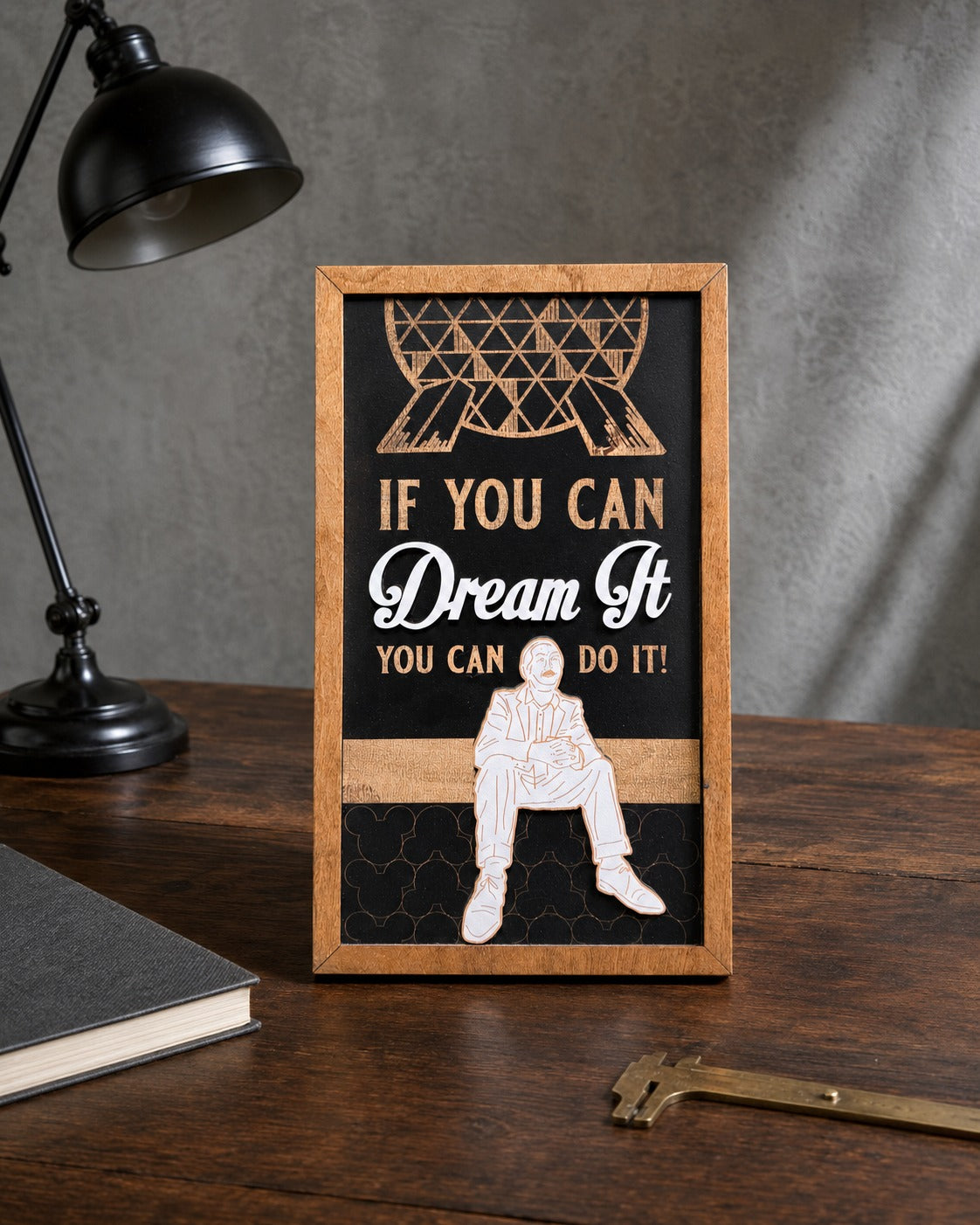 If You Can Dream It You Can Do It geodesic sphere framed wood sign styled on a dark oak desk