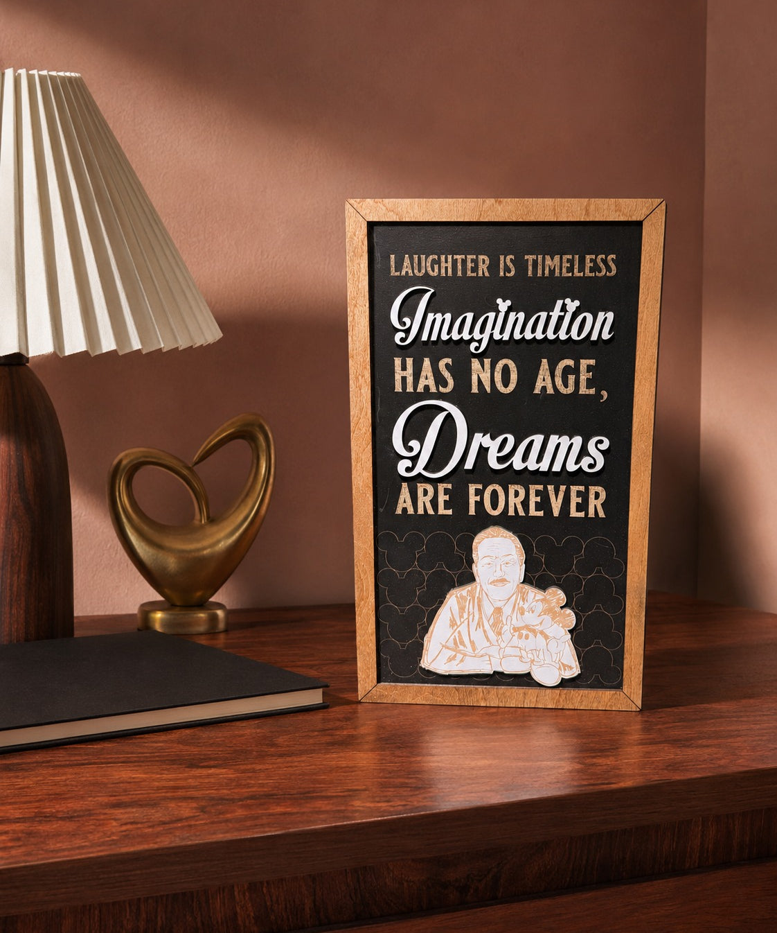 Laughter Is Timeless Imagination Has No Age framed wood sign styled in a rosewood reading room