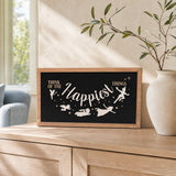 Think Of The Happiest Things Neverland framed wood sign styled on a sunlit oak console
