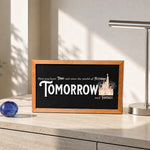 Here You Leave Today castle tribute framed wood sign styled on a sunlit travertine credenza