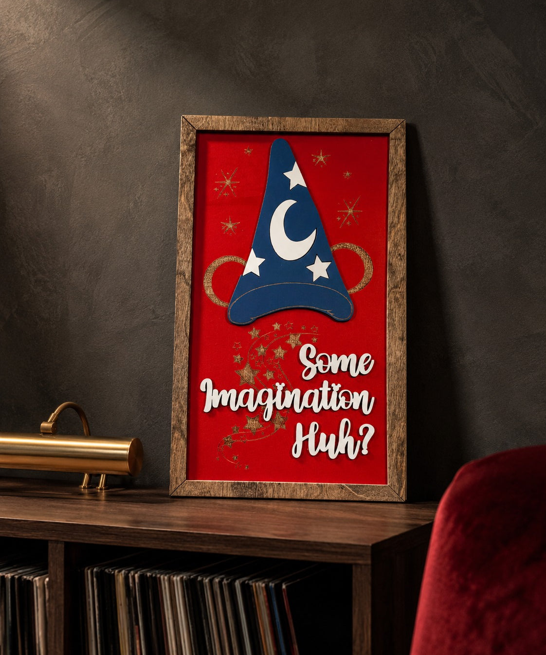Some Imagination Huh red sorcerer hat framed wood sign styled on a smoked oak console