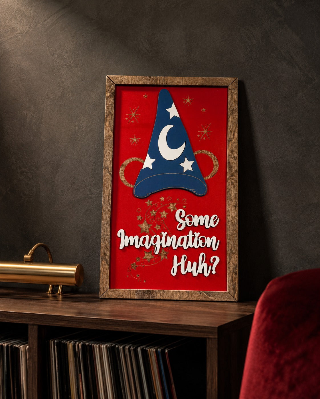 Some Imagination Huh red sorcerer hat framed wood sign styled on a smoked oak console