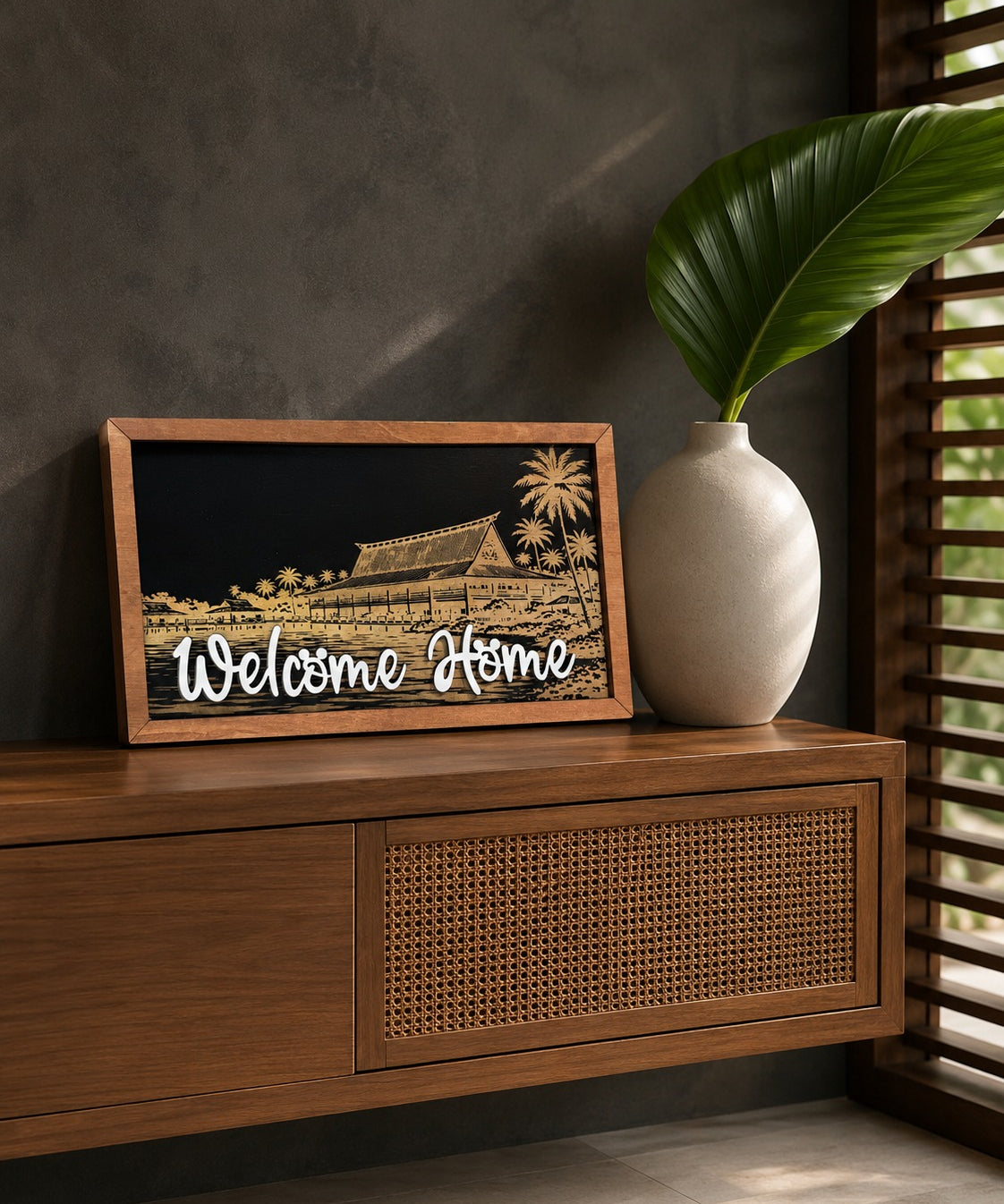 Welcome Home Polynesian island resort framed wood sign styled on a teak sideboard