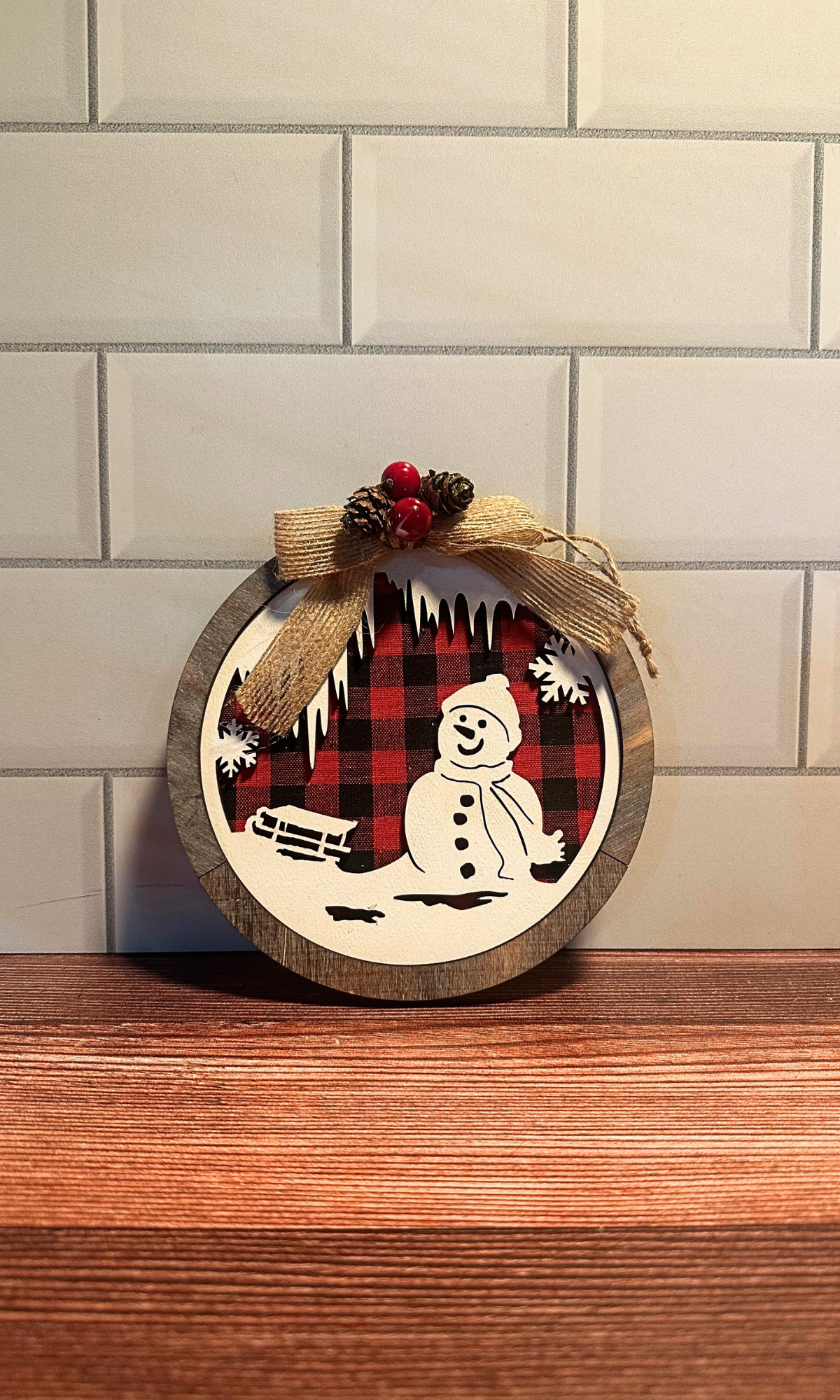 Round Wooden Red/Black Plaid Snowman Scene Ornament