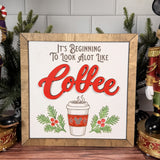 It's Beginning to Look a Lot Like Coffee square Christmas sign with red layered Coffee lettering, a takeaway cup, evergreen sprigs and a brown wood frame.