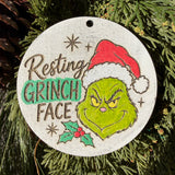 Finished hand-painted Resting Grinch Face on evergreen greenery.
