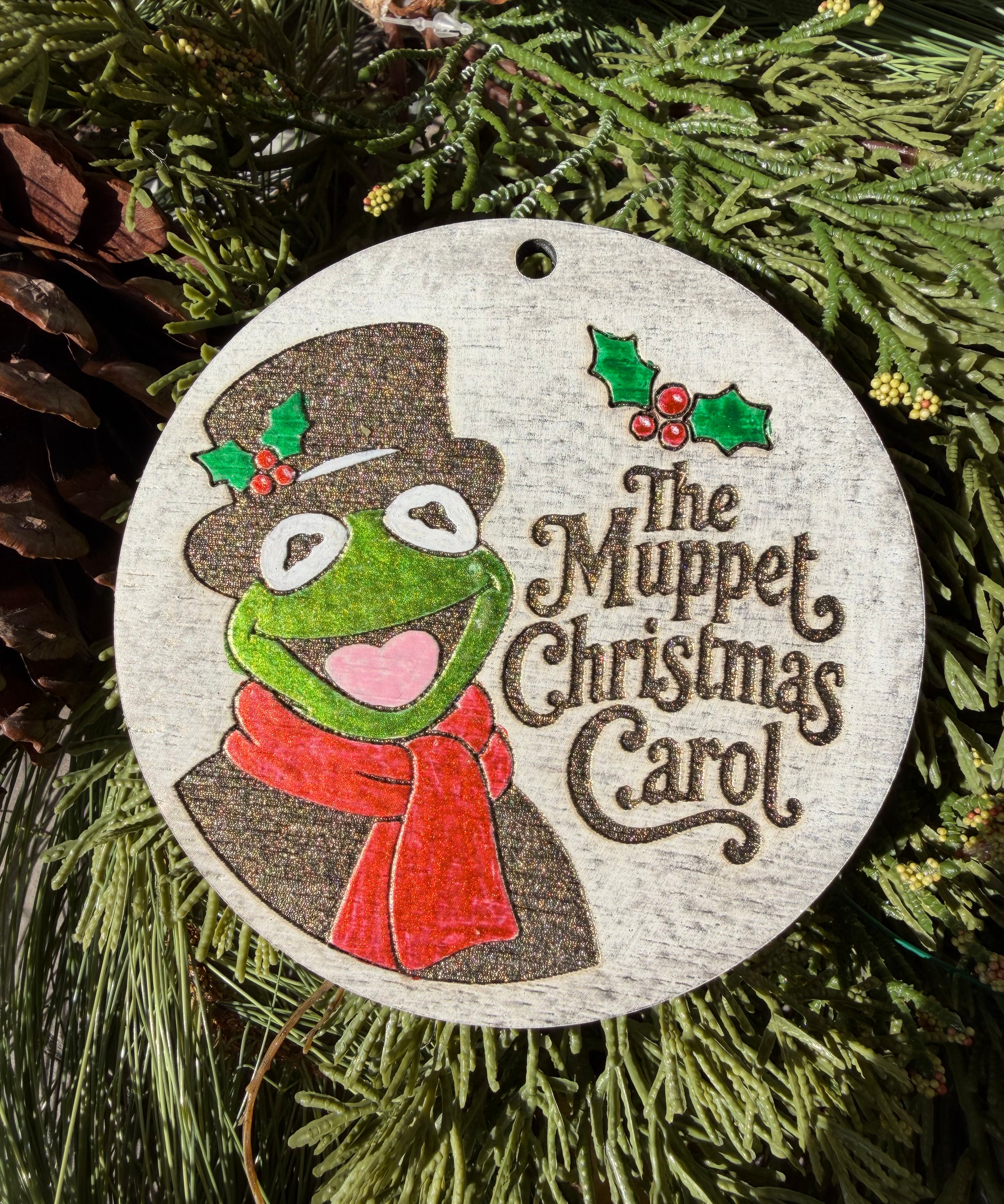 Finished hand-painted The Muppet Christmas Carol on evergreen greenery.