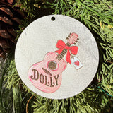 Finished hand-painted Dolly Pink Guitar & Bow on evergreen greenery.