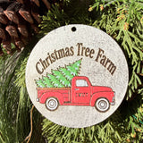 Finished hand-painted Christmas Tree Farm Red Truck on evergreen greenery.