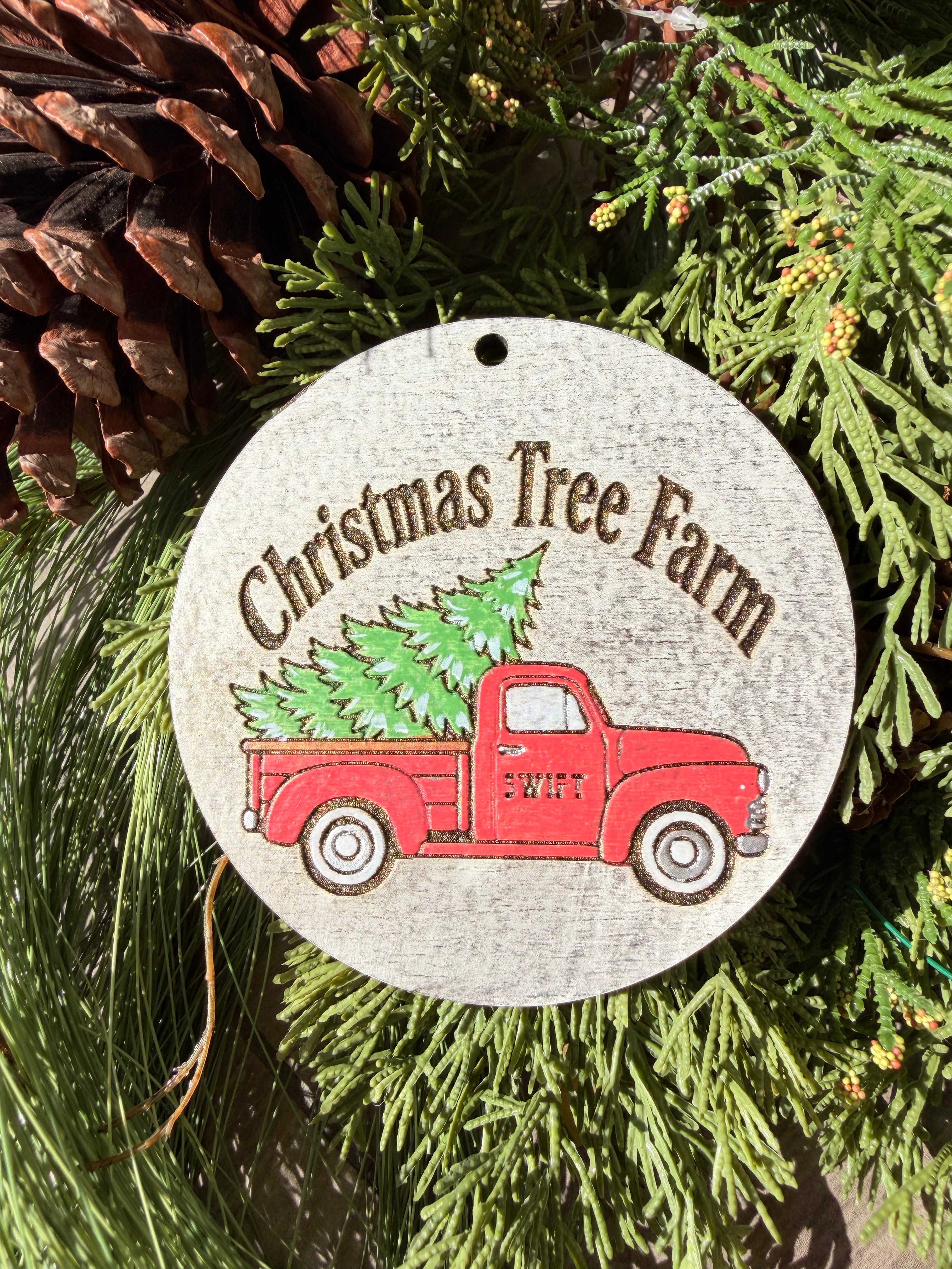 Finished hand-painted Christmas Tree Farm Red Truck on evergreen greenery.