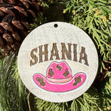 Finished hand-painted Shania Pink Cowboy Hat on evergreen greenery.