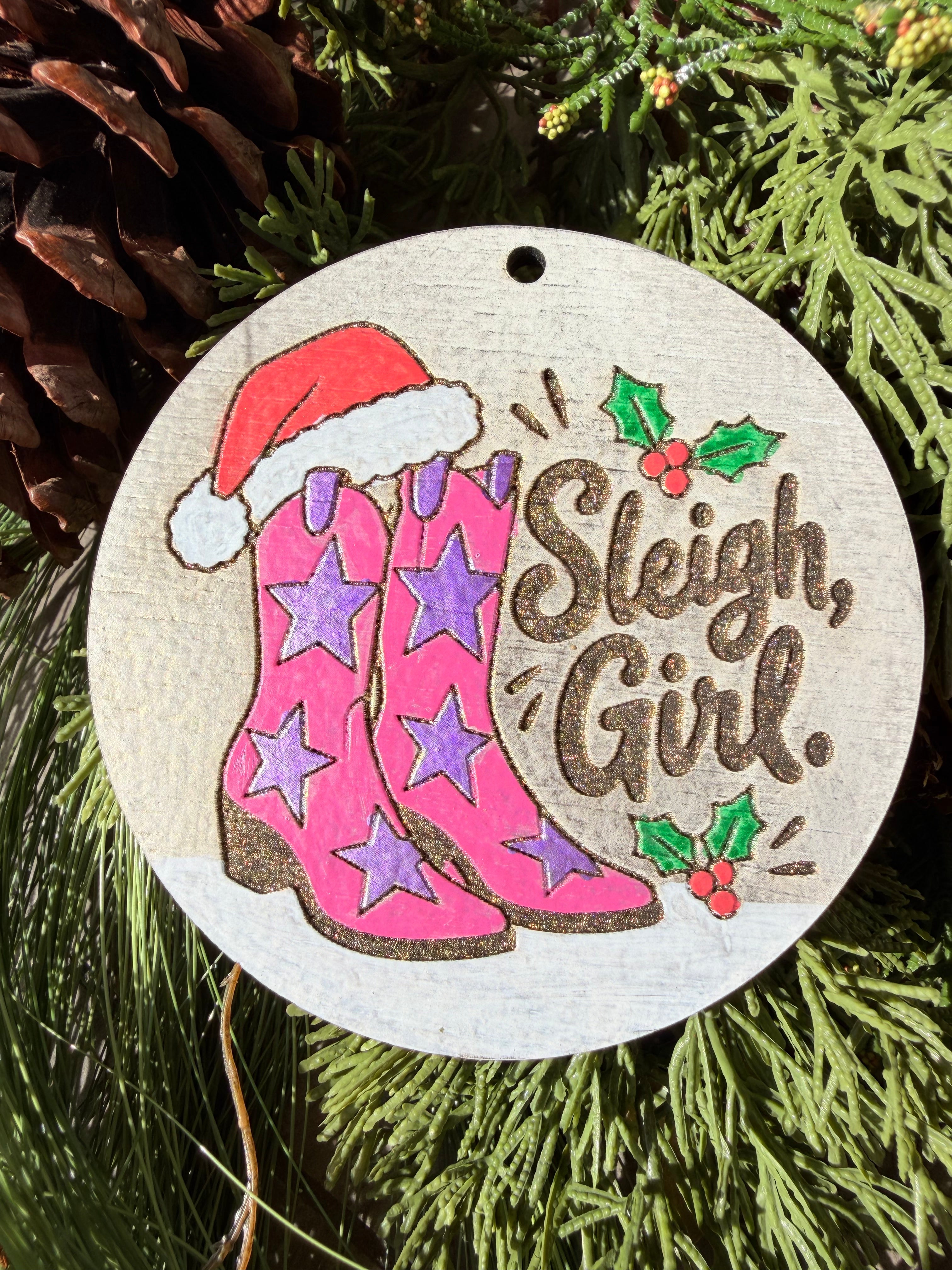 Finished hand-painted Sleigh, Girl! Cowboy Boots on evergreen greenery.
