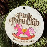 Finished hand-painted Pink Pony Club Christmas Chapter on evergreen greenery.