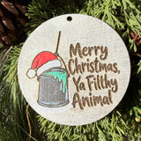 Finished hand-painted Merry Christmas, Ya Filthy Animal on evergreen greenery.