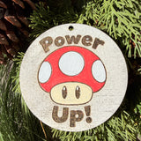 Finished hand-painted Power Up! Mushroom on evergreen greenery.