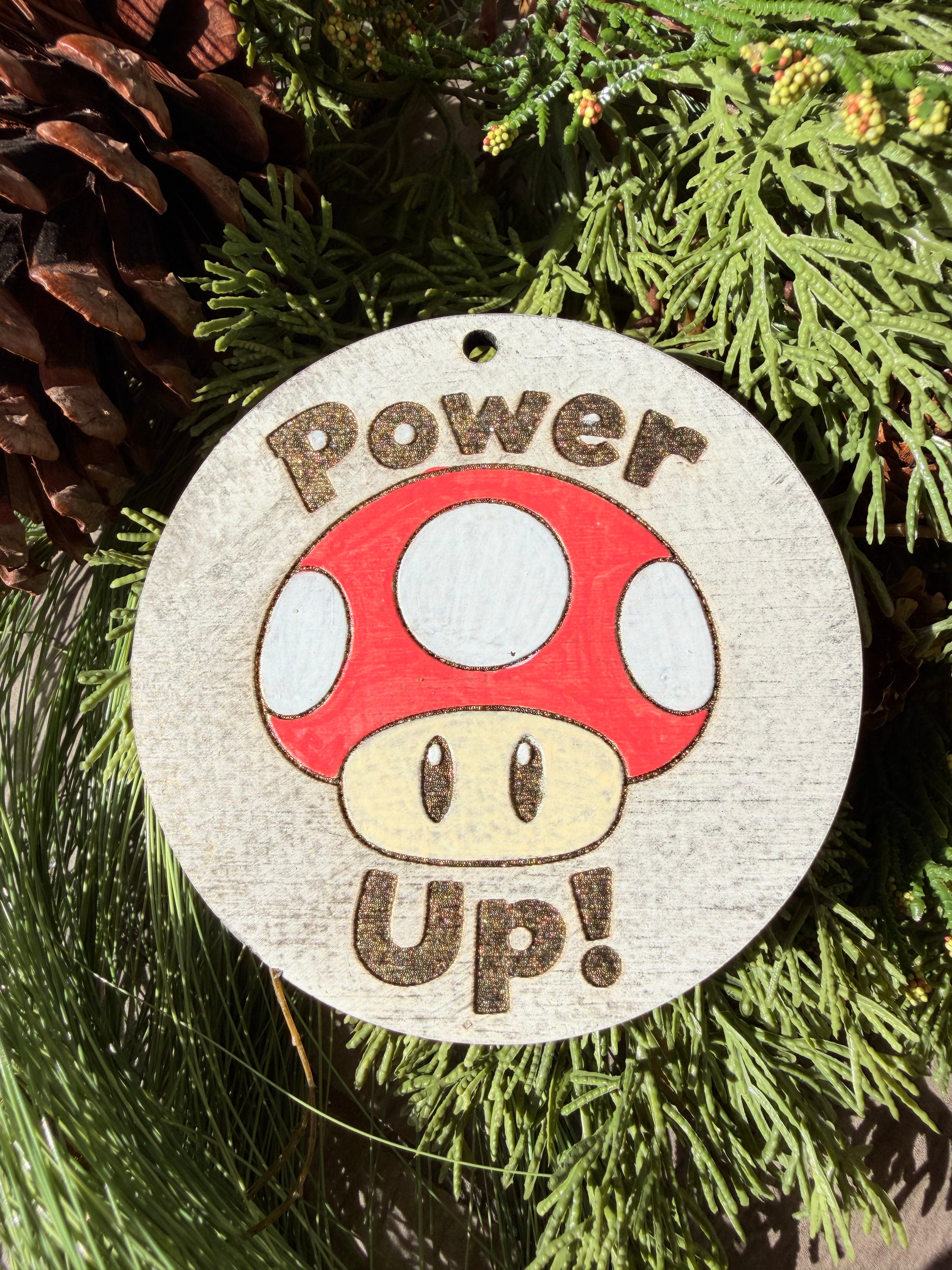 Finished hand-painted Power Up! Mushroom on evergreen greenery.