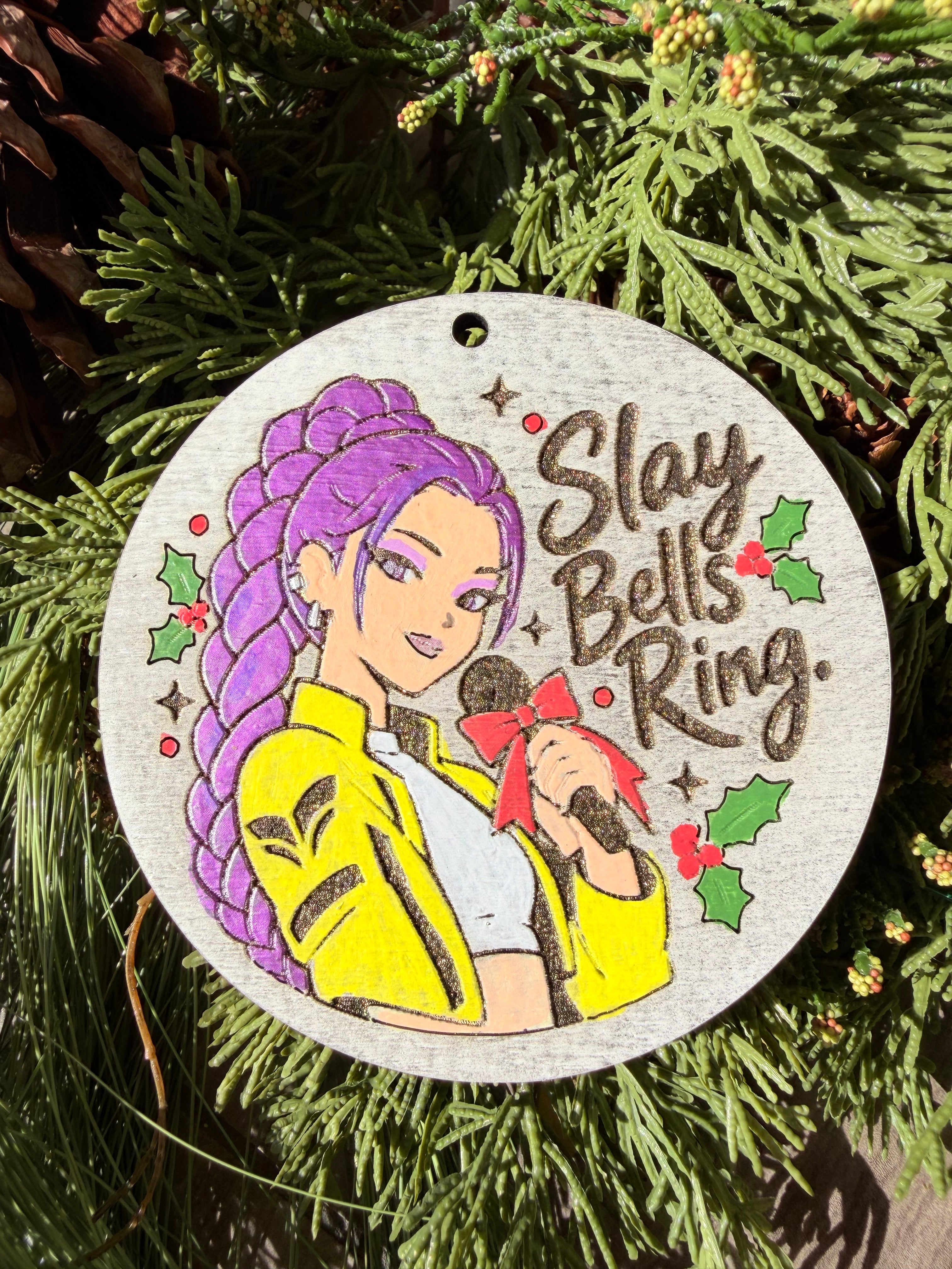 Finished hand-painted Slay Bells Ring on evergreen greenery.