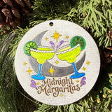 Finished hand-painted Midnight Margaritas on evergreen greenery.