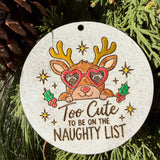 Finished hand-painted Too Cute for the Naughty List on evergreen greenery.