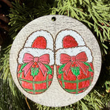 Finished hand-painted Cozy Plaid Slippers on evergreen greenery.