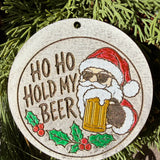 Finished hand-painted Ho Ho Hold My Beer on evergreen greenery.