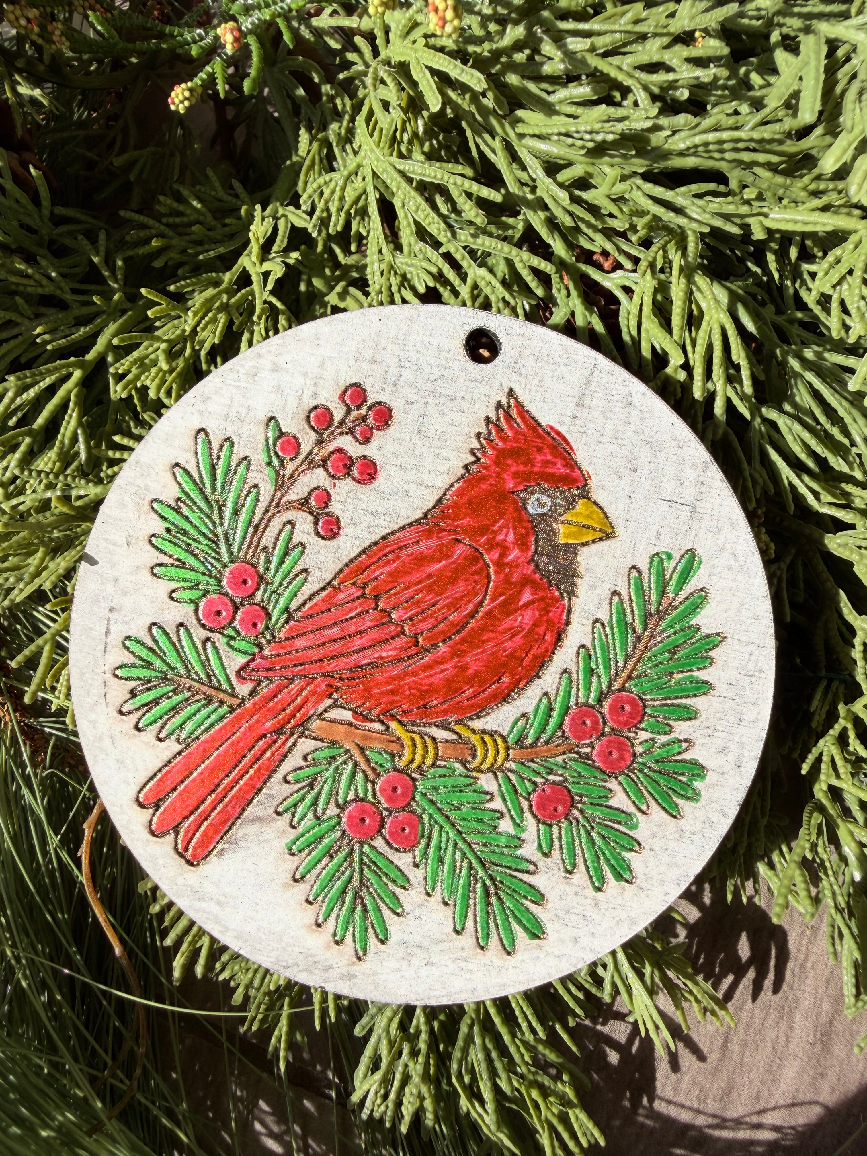 Finished hand-painted Winter Cardinal on evergreen greenery.