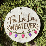 Finished hand-painted Fa La La Whatever on evergreen greenery.