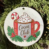 Finished hand-painted Cocoa Club on evergreen greenery.