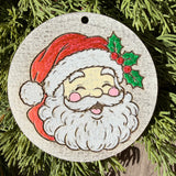 Finished hand-painted Jolly Santa on evergreen greenery.