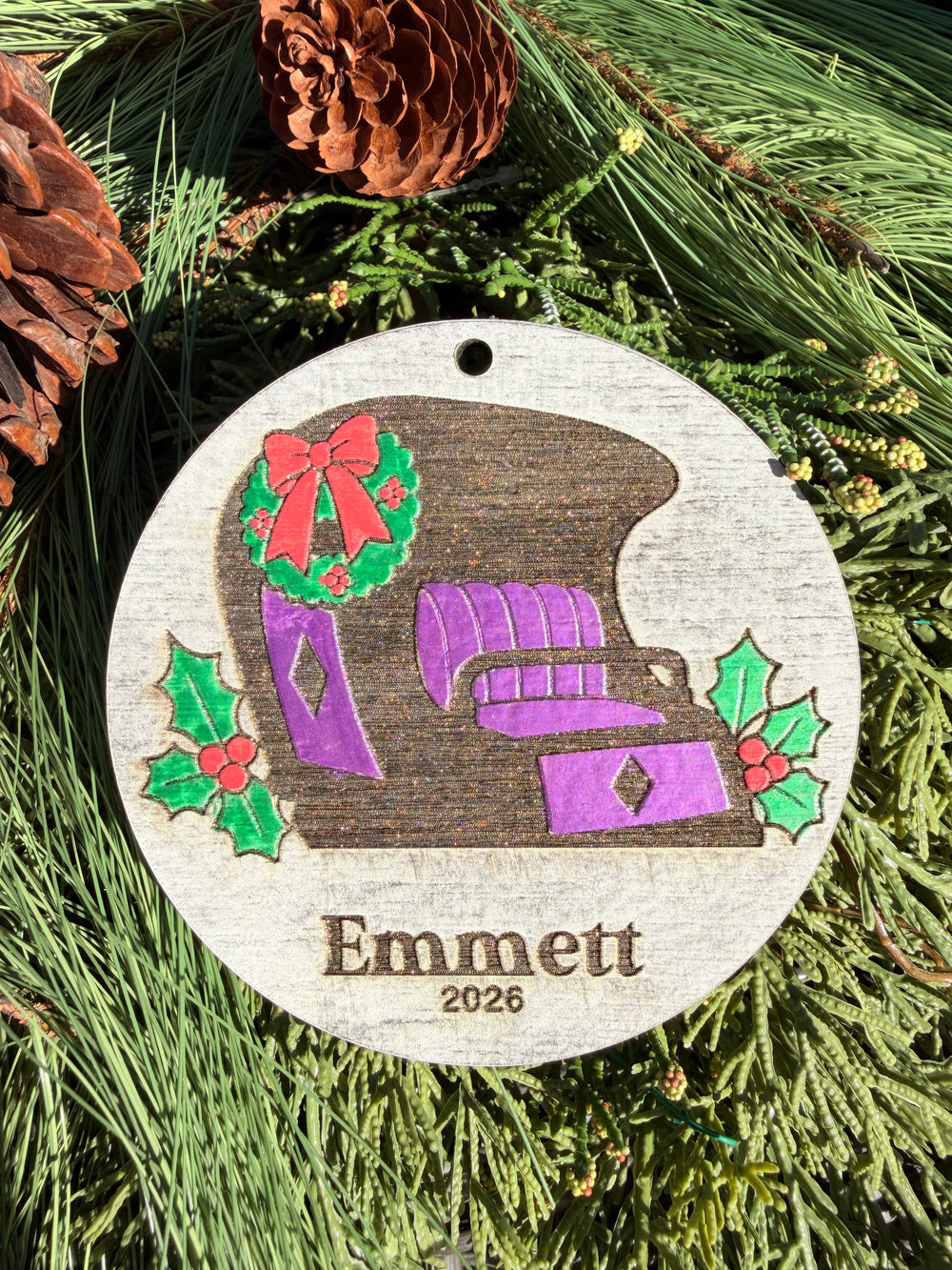 Finished hand-painted Doom Buggy Christmas Ornament on evergreen greenery. Name and year shown are sample personalization.