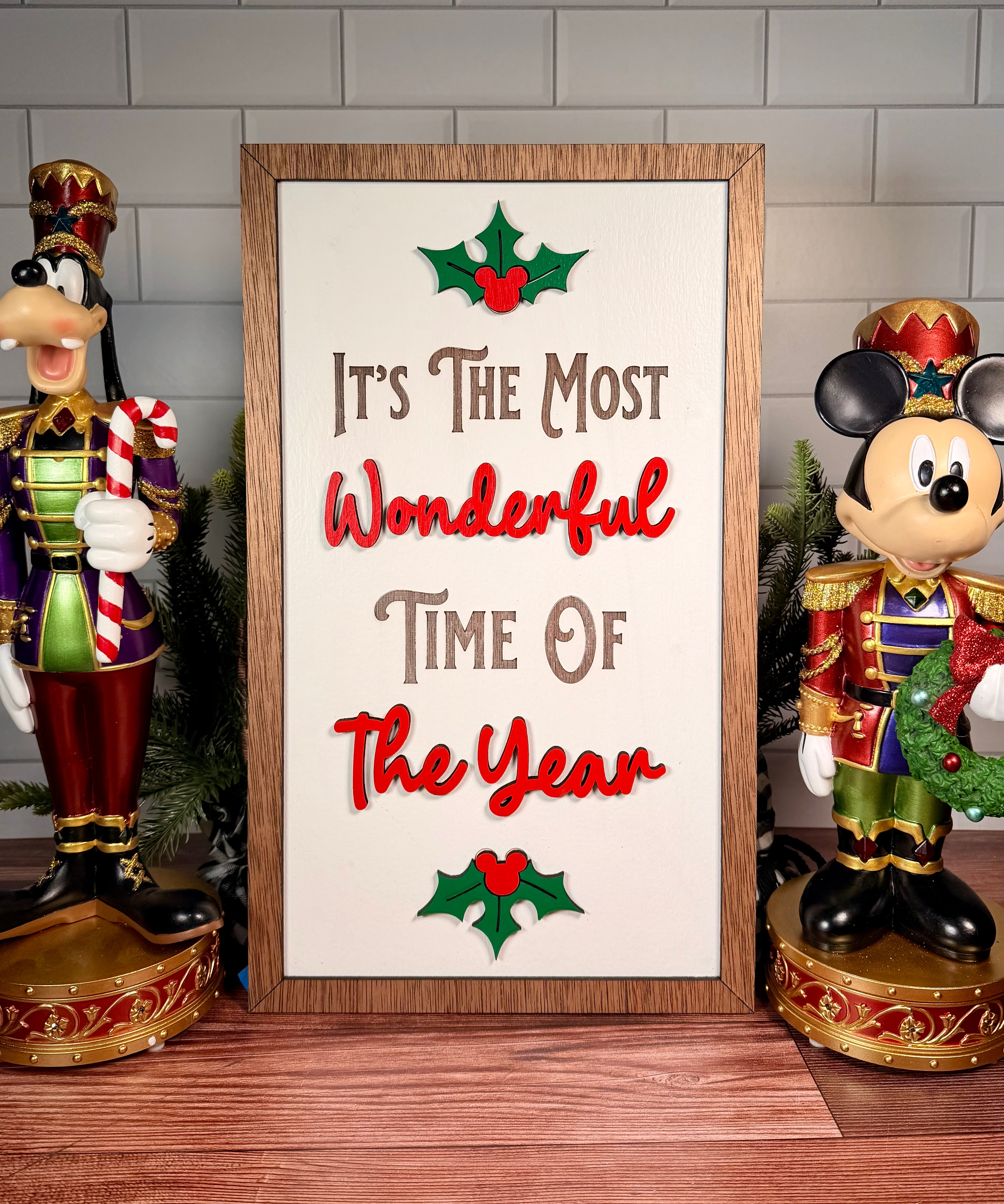It's the Most Wonderful Time of the Year vertical Christmas sign with red lettering, green holly and a brown wood frame.