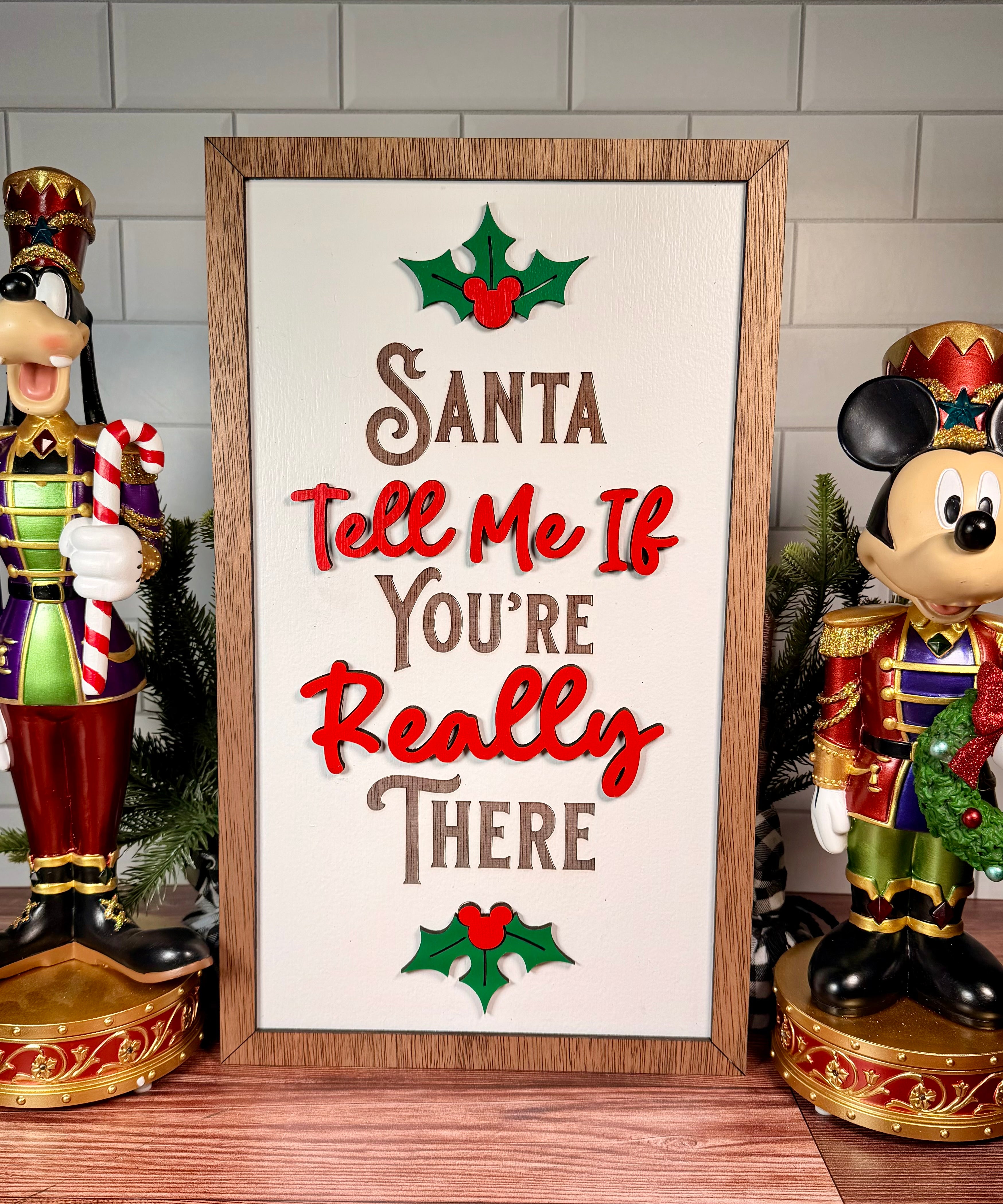 Santa Tell Me If You're Really There vertical Christmas sign with red lettering, green holly and a brown wood frame.