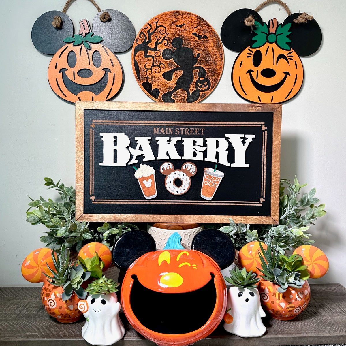 Main Street Bakery framed sign styled in Justin’s home with autumn decorations and greenery.